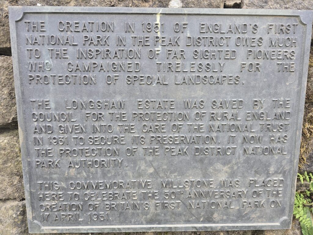 A commemorative plaque describing the history of the Peak District as England’s first National Park and the efforts to preserve Longshaw Estate.
