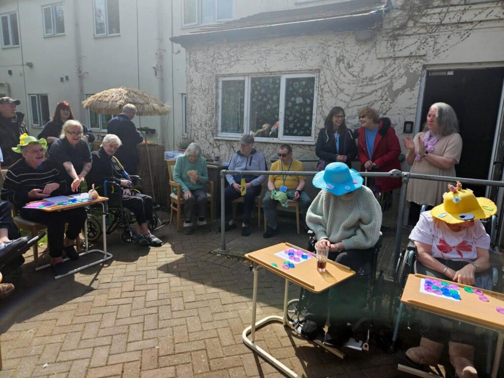 Residents and staff gathered in the care home courtyard, taking part in games and watching the Easter celebrations.